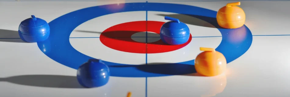 Mini curling game board with six stones, three orange and three blue, on a white surface with a red and blue target.