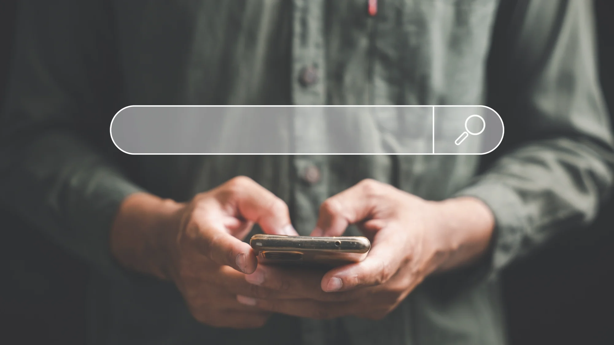 man holing a phone with a search bar govering above the phone