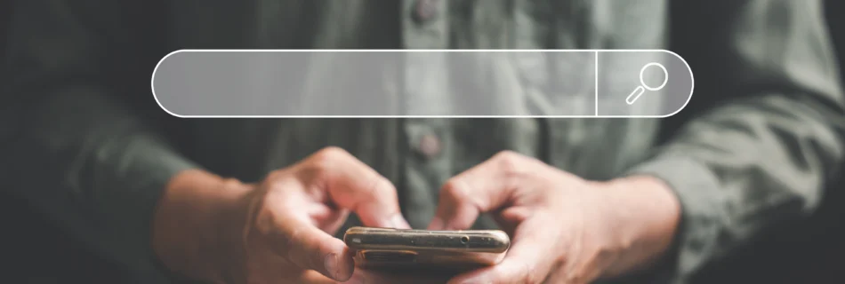 man holing a phone with a search bar govering above the phone