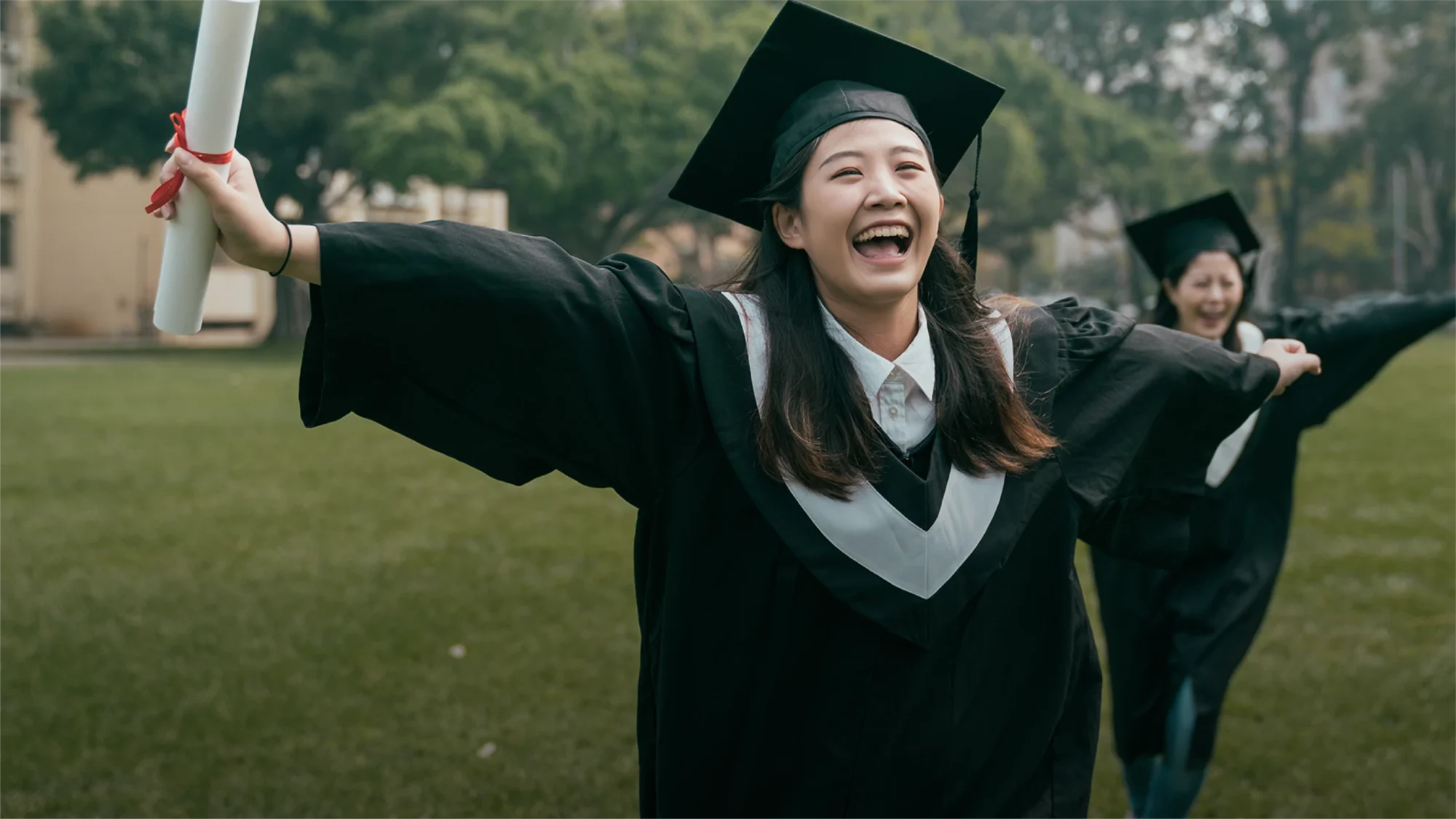 Curtin University 2024 Chinese girl celebrating by running on campus after graduating with degree in her hand