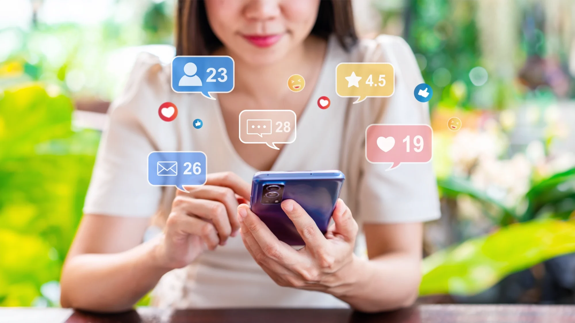 Asian woman uses a smartphone while marketing icons for social media interactions, like comments and likes, appear around her.